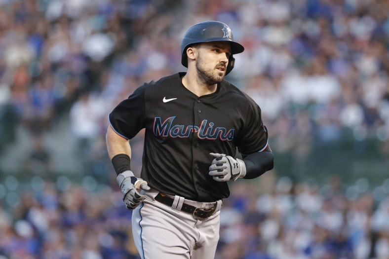 Jun 18, 2021; Chicago, Illinois, USA; Miami Marlins left fielder Adam Duvall (14) rounds the bases after hitting a grand slam off Chicago Cubs starting pitcher Zach Davies (not pictured) during the third inning at Wrigley Field. Mandatory Credit: Kamil Krzaczynski-USA TODAY Sports