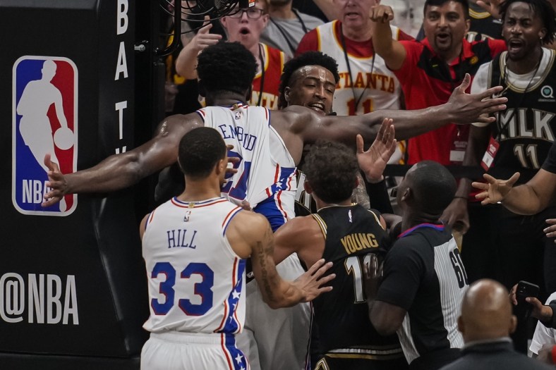 Jun 18, 2021; Atlanta, Georgia, USA; Philadelphia 76ers center Joel Embiid (21) and Atlanta Hawks forward John Collins (20) get involved in a shoving match leading to both receiving technical fouls during the second half during game six in the second round of the 2021 NBA Playoffs. at State Farm Arena. Mandatory Credit: Dale Zanine-USA TODAY Sports
