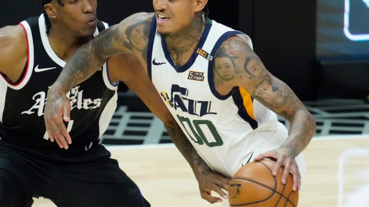 Jun 18, 2021; Los Angeles, California, USA; Utah Jazz guard Jordan Clarkson (00) dribbles the ball past LA Clippers guard Terance Mann (14) in the second quarter during game six in the second round of the 2021 NBA Playoffs at Staples Center. Mandatory Credit: Robert Hanashiro-USA TODAY Sports