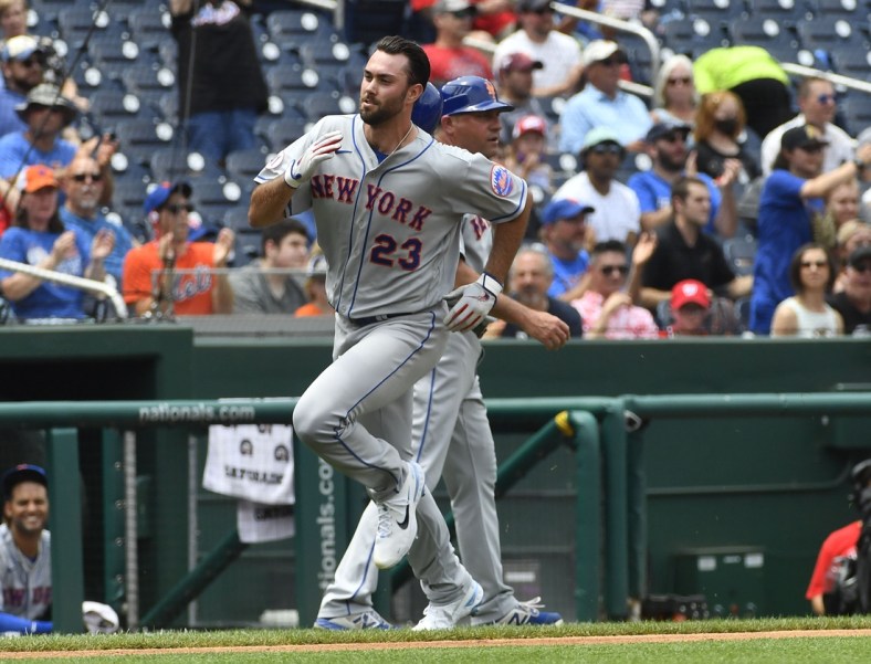 Jun 19, 2021; Washington, District of Columbia, USA; New York Mets starting pitcher David Peterson (23) scores a run against the Washington Nationals during the third inning at Nationals Park. Mandatory Credit: Brad Mills-USA TODAY Sports