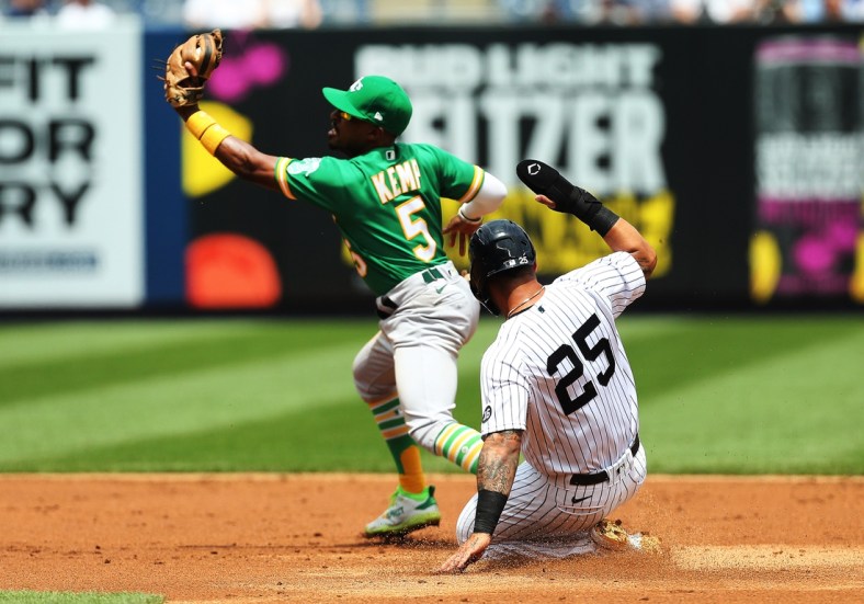Jun 19, 2021; Bronx, New York, USA; New York Yankees shortstop Gleyber Torres (25) is forced out at second base by Oakland Athletics second baseman Tony Kemp (5) on the first part of a double play during the second inning at Yankee Stadium. Mandatory Credit: Andy Marlin-USA TODAY Sports