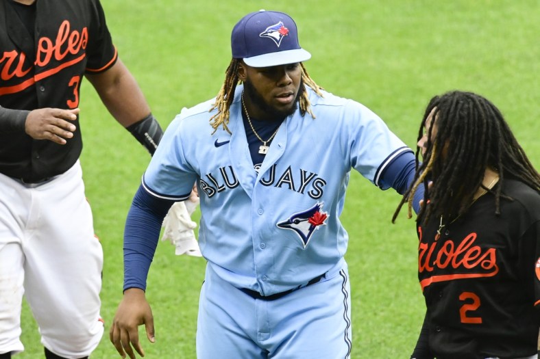Jun 19, 2021; Baltimore, Maryland, USA; Toronto Blue Jays designated hitter Vladimir Guerrero Jr. (27) hold Baltimore Orioles shortstop Freddy Galvis (2) back after benches cleared in the fourth inning at Oriole Park at Camden Yards. Mandatory Credit: Tommy Gilligan-USA TODAY Sports