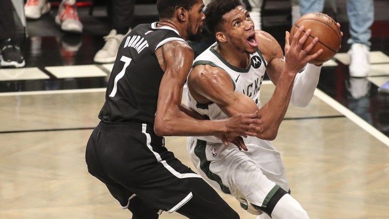 Jun 19, 2021; Brooklyn, New York, USA; Milwaukee Bucks forward Giannis Antetokounmpo (34) drives past Brooklyn Nets forward Kevin Durant (7) in the third quarter during game seven in the second round of the 2021 NBA Playoffs at Barclays Center. Mandatory Credit: Wendell Cruz-USA TODAY Sports