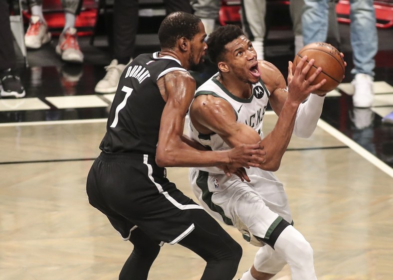 Jun 19, 2021; Brooklyn, New York, USA; Milwaukee Bucks forward Giannis Antetokounmpo (34) drives past Brooklyn Nets forward Kevin Durant (7) in the third quarter during game seven in the second round of the 2021 NBA Playoffs at Barclays Center. Mandatory Credit: Wendell Cruz-USA TODAY Sports