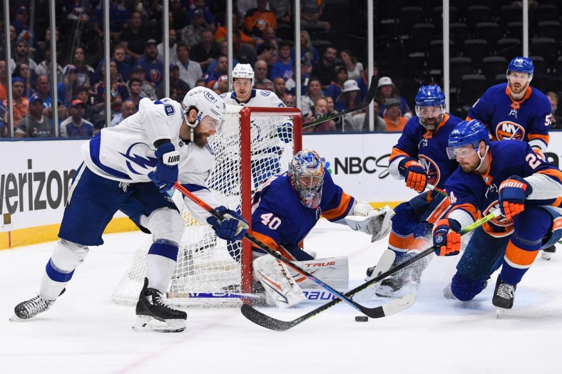 Jun 19, 2021; Uniondale, New York, USA; Tampa Bay Lightning right wing Barclay Goodrow (19) attempts a wrap around on New York Islanders goaltender Semyon Varlamov (40) as New York Islanders defenseman Scott Mayfield (24) blocks him during the third period in game four of the 2021 Stanley Cup Semifinals at Nassau Veterans Memorial Coliseum. Mandatory Credit: Dennis Schneidler-USA TODAY Sports