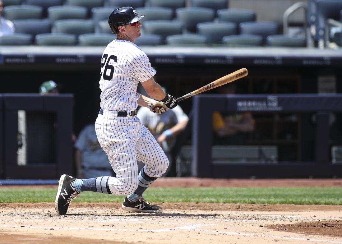 Jun 20, 2021; Bronx, New York, USA; New York Yankees second baseman DJ LeMahieu (26) hits a double in the third inning against the Oakland Athletics at Yankee Stadium. Mandatory Credit: Wendell Cruz-USA TODAY Sports