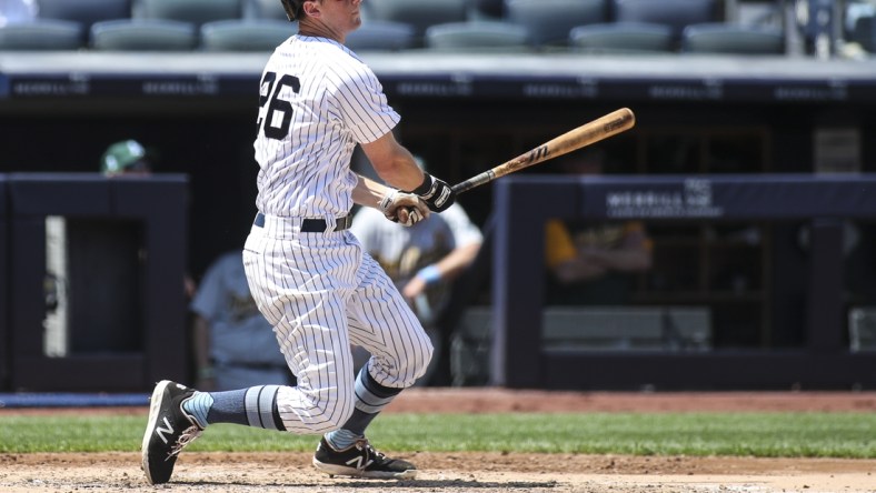 Jun 20, 2021; Bronx, New York, USA; New York Yankees second baseman DJ LeMahieu (26) hits a double in the third inning against the Oakland Athletics at Yankee Stadium. Mandatory Credit: Wendell Cruz-USA TODAY Sports