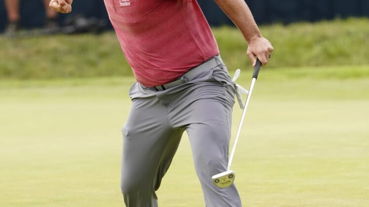 Jun 20, 2021; San Diego, California, USA; Jon Rahm reacts to his birdie putt on the 18th green during the final round of the U.S. Open golf tournament at Torrey Pines Golf Course. Mandatory Credit: Michael Madrid-USA TODAY Sports