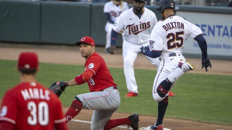 Jun 21, 2021; Minneapolis, Minnesota, USA; Minnesota Twins center fielder Byron Buxton (25) reaches first base before Cincinnati Reds first baseman Joey Votto (19) can catch the ball for a single in the second inning at Target Field. Mandatory Credit: Jesse Johnson-USA TODAY Sports