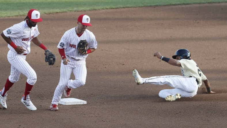 Jun 21, 2021; Omaha, Nebraska, USA;  NC State Wolfpack second baseman J.T. Jarrett (15) tags out Vanderbilt Commodores left fielder Javier Vaz (2) at TD Ameritrade Park. Mandatory Credit: Bruce Thorson-USA TODAY Sports