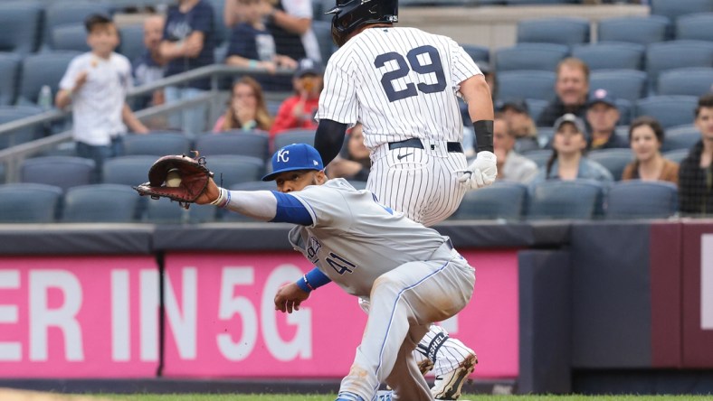 Jun 22, 2021; Bronx, New York, USA; New York Yankees third baseman Gio Urshela (29) beats the throw caught by Kansas City Royals first baseman Carlos Santana (41) during the first inning at Yankee Stadium. Mandatory Credit: Vincent Carchietta-USA TODAY Sports