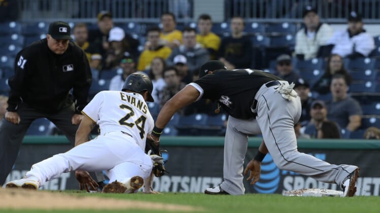 Jun 22, 2021; Pittsburgh, Pennsylvania, USA;  Pittsburgh Pirates left fielder Phillip Evans (24) is tagged out at first base by Chicago White Sox first baseman Jose Abreu (79) on a pick-off during the second inning at PNC Park. Mandatory Credit: Charles LeClaire-USA TODAY Sports