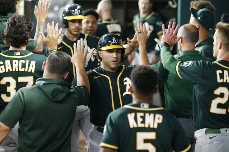 Jun 22, 2021; Arlington, Texas, USA; Oakland Athletics designated hitter Ramon Laureano (22) is congratulated by his teammates after hitting a home run in the second inning against the Texas Rangers at Globe Life Field. Mandatory Credit: Tim Heitman-USA TODAY Sports