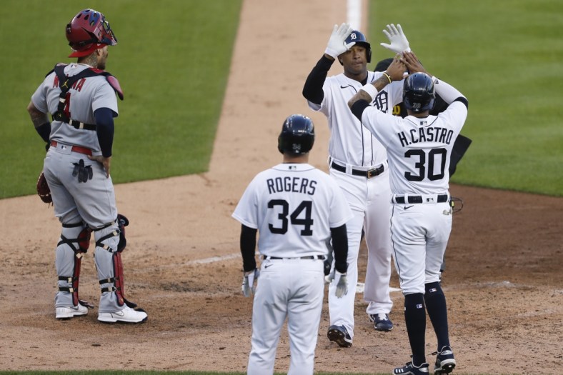 Jun 22, 2021; Detroit, Michigan, USA; Detroit Tigers second baseman Jonathan Schoop (7) celebrates with shortstop Harold Castro (30) and catcher Jake Rogers (34) after hitting a three run home run during the fourth inning against the St. Louis Cardinals at Comerica Park. Mandatory Credit: Raj Mehta-USA TODAY Sports