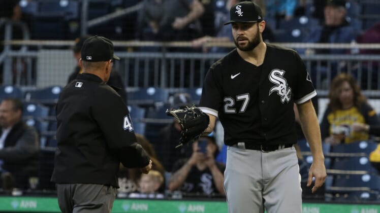 Jun 22, 2021; Pittsburgh, Pennsylvania, USA;  Umpire Jerry Meals (41) checks the glove of Chicago White Sox starting pitcher Lucas Giolito (27) for foreign substances after Giolito pitched the fifth inning against the Pittsburgh Pirates at PNC Park. Mandatory Credit: Charles LeClaire-USA TODAY Sports