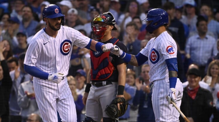 Jun 22, 2021; Chicago, Illinois, USA;  Chicago Cubs first baseman Kris Bryant (left) fist bumps shortstop Javier Baez (9) after hitting a home run against the Cleveland Indians during the fourth inning at Wrigley Field. Mandatory Credit: Matt Marton-USA TODAY Sports