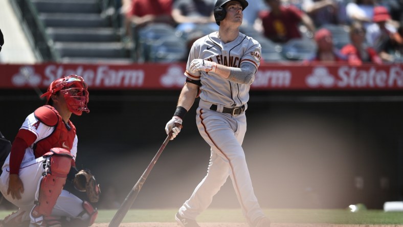 Jun 23, 2021; Anaheim, California, USA; San Francisco Giants right fielder Mike Yastrzemski (5) follows through on a swing for a solo home run during the fifth inning against the Los Angeles Angels at Angel Stadium. Mandatory Credit: Kelvin Kuo-USA TODAY Sports