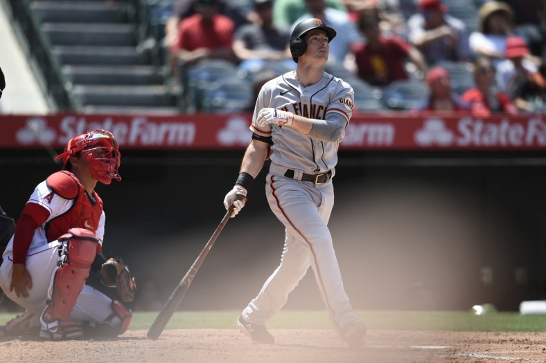 Jun 23, 2021; Anaheim, California, USA; San Francisco Giants right fielder Mike Yastrzemski (5) follows through on a swing for a solo home run during the fifth inning against the Los Angeles Angels at Angel Stadium. Mandatory Credit: Kelvin Kuo-USA TODAY Sports