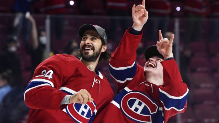 Jun 24, 2021; Montreal, Quebec, CAN; Montreal Canadiens players celebrate after winning game six of the 2021 Stanley Cup Semifinals against the Vegas Golden Knights at the Bell Centre. Mandatory Credit: Eric Bolte-USA TODAY Sports