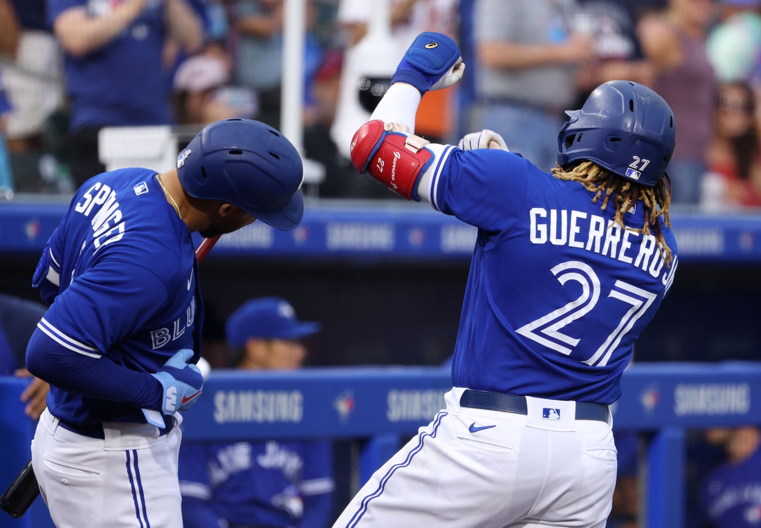 Jun 25, 2021; Buffalo, New York, USA;  Toronto Blue Jays first baseman Vladimir Guerrero Jr. (27) celebrates his home run with center fielder George Springer (4) during the third inning against Baltimore Orioles at Sahlen Field. Mandatory Credit: Timothy T. Ludwig-USA TODAY Sports