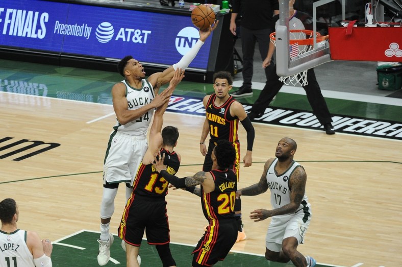Jun 25, 2021; Milwaukee, Wisconsin, USA; Milwaukee Bucks forward Giannis Antetokounmpo (34) shoots the ball over Atlanta Hawks guard Bogdan Bogdanovic (13) in the first quarter during game two of the Eastern Conference Finals for the 2021 NBA Playoffs at Fiserv Forum. Mandatory Credit: Michael McLoone-USA TODAY Sports
