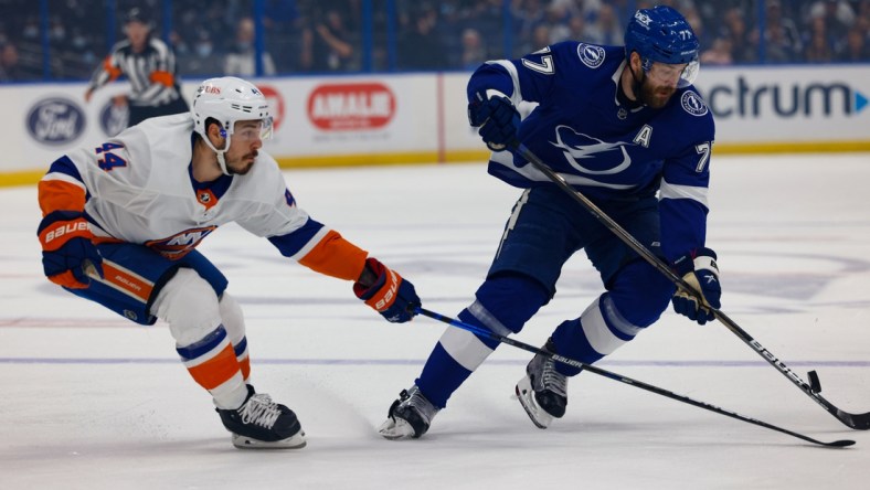 Jun 25, 2021; Tampa, Florida, USA; Tampa Bay Lightning defenseman Victor Hedman (77) handles the puck past New York Islanders center Jean-Gabriel Pageau (44) during the first period in game seven of the Stanley Cup Semifinals at Amalie Arena. Mandatory Credit: Nathan Ray Seebeck-USA TODAY Sports