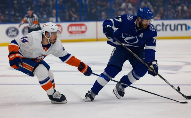 Jun 25, 2021; Tampa, Florida, USA; Tampa Bay Lightning defenseman Victor Hedman (77) handles the puck past New York Islanders center Jean-Gabriel Pageau (44) during the first period in game seven of the Stanley Cup Semifinals at Amalie Arena. Mandatory Credit: Nathan Ray Seebeck-USA TODAY Sports