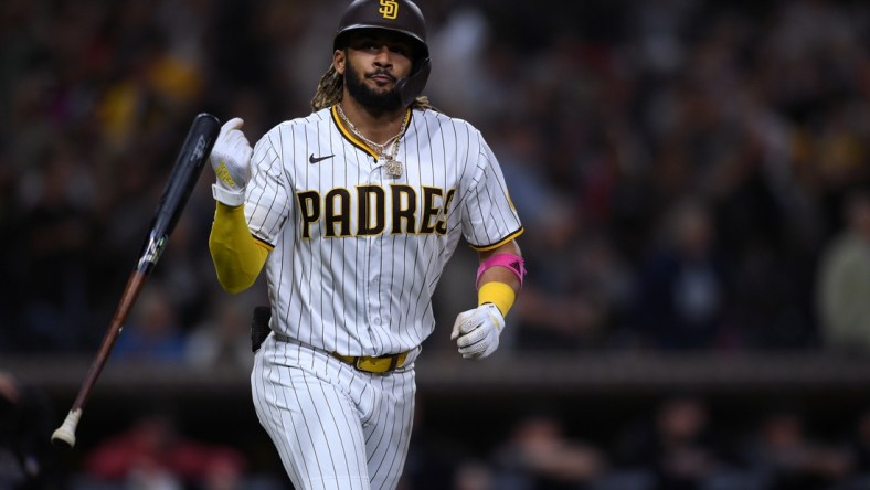 Jun 25, 2021; San Diego, California, USA; San Diego Padres shortstop Fernando Tatis Jr. (23) flips his bat after hitting a two-run home run against the Arizona Diamondbacks during the fourth inning at Petco Park. Mandatory Credit: Orlando Ramirez-USA TODAY Sports