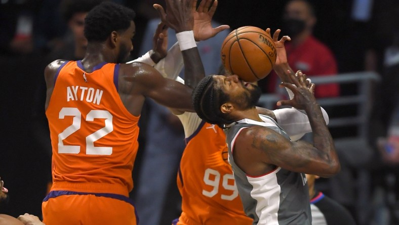 Jun 26, 2021; Los Angeles, California, USA; Los Angeles Clippers guard Paul George (13) drives to the basket against Phoenix Suns center Deandre Ayton (22) and forward Jae Crowder (99) in the first half of game four of the Western Conference Finals for the 2021 NBA Playoffs at Staples Center. Mandatory Credit: Jayne Kamin-Oncea-USA TODAY Sports