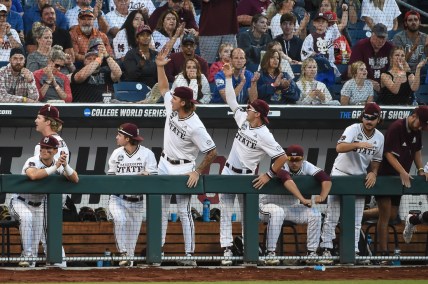 Jun 26, 2021; Omaha, Nebraska, USA; The Mississippi State Bulldogs bench leads the cheers in the ninth inning against the Texas Longhorns at TD Ameritrade Park. Mandatory Credit: Steven Branscombe-USA TODAY Sports