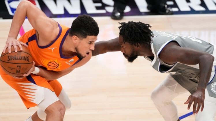 Jun 26, 2021; Los Angeles, California, USA; Phoenix Suns guard Devin Booker (1) and LA Clippers guard Patrick Beverley (21) face off during the fourth quarter of game four of the Western Conference Finals for the 2021 NBA Playoffs at Staples Center. Mandatory Credit: Robert Hanashiro-USA TODAY Sports