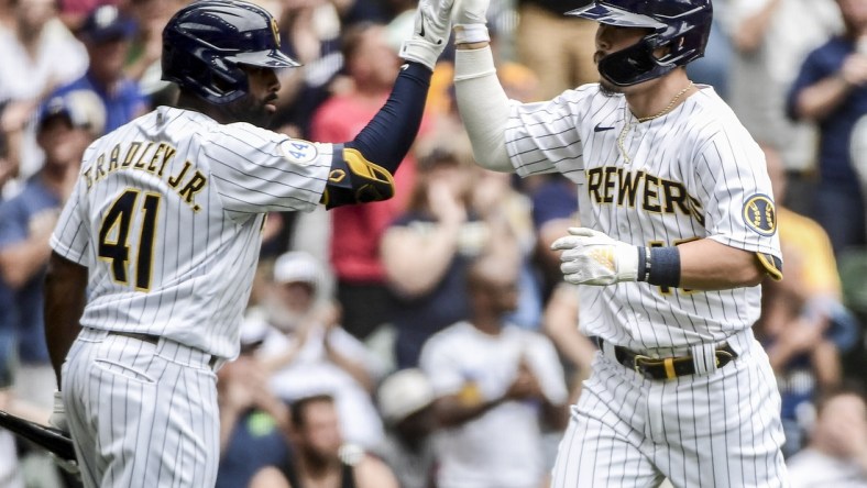 Jun 27, 2021; Milwaukee, Wisconsin, USA; Milwaukee Brewers first baseman Keston Hiura (18) is greeted by center fielder Jackie Bradley Jr. (41) after hitting a solo home run in the third inning against the Colorado Rockies at American Family Field. Mandatory Credit: Benny Sieu-USA TODAY Sports