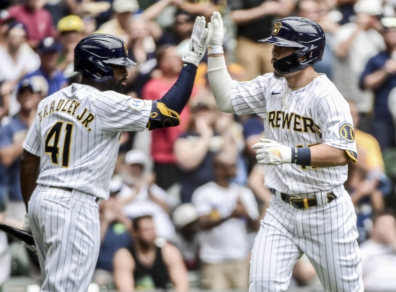 Jun 27, 2021; Milwaukee, Wisconsin, USA; Milwaukee Brewers first baseman Keston Hiura (18) is greeted by center fielder Jackie Bradley Jr. (41) after hitting a solo home run in the third inning against the Colorado Rockies at American Family Field. Mandatory Credit: Benny Sieu-USA TODAY Sports