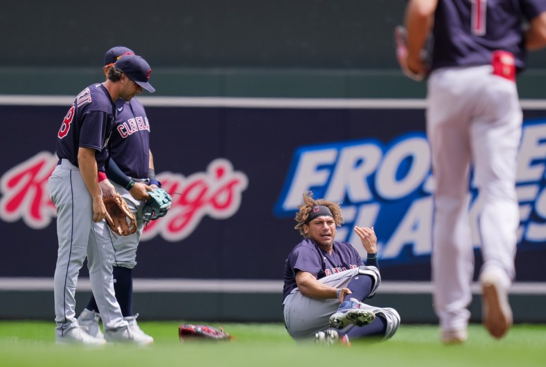 Jun 27, 2021; Minneapolis, Minnesota, USA; Cleveland Indians outfielder Josh Naylor (22) calls for medial attention after colliding with  second baseman Ernie Clement (28) in the fourth innings against the Minnesota Twins  at Target Field. Mandatory Credit: Brad Rempel-USA TODAY Sports