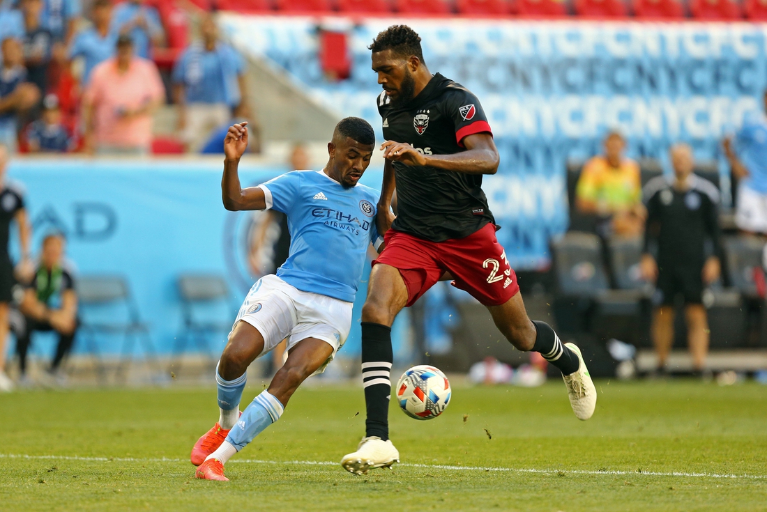 Jun 27, 2021; Harrison, New Jersey, USA; New York City FC forward Thiago Andrade (8) kicks the game-winning goal while D.C. United defender Donovan Pines (23) tries to defend during the second half of a game between D.C. United and NYCFC at Red Bull Arena. Mandatory Credit: Danny Wild-USA TODAY Sports