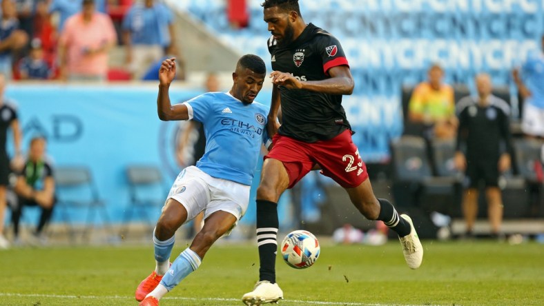 Jun 27, 2021; Harrison, New Jersey, USA; New York City FC forward Thiago Andrade (8) kicks the game-winning goal while D.C. United defender Donovan Pines (23) tries to defend during the second half of a game between D.C. United and NYCFC at Red Bull Arena. Mandatory Credit: Danny Wild-USA TODAY Sports