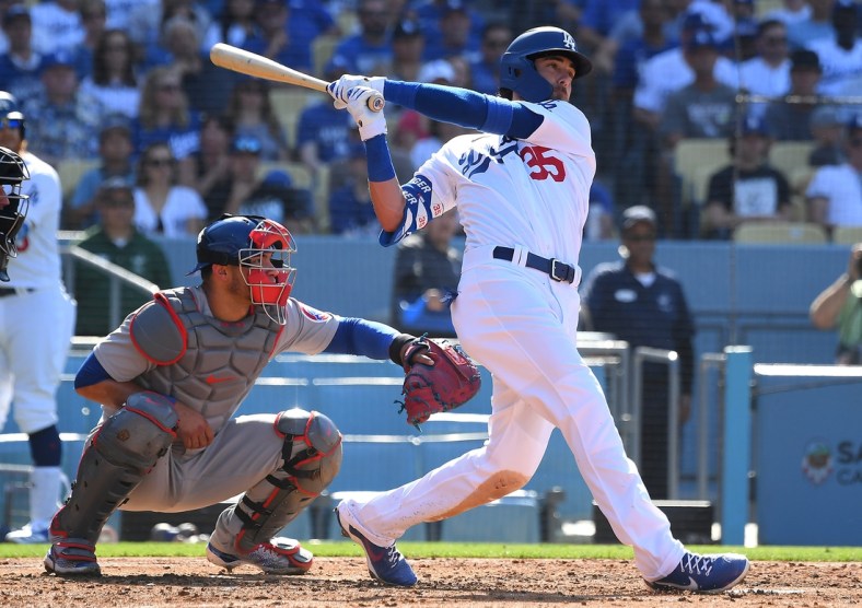 Jun 27, 2021; Los Angeles, California, USA;   Los Angeles Dodgers center fielder Cody Bellinger (35) hits a two run home run off of Chicago Cubs starting pitcher Adbert Alzolay (73) in the second inning of the game at Dodger Stadium. Mandatory Credit: Jayne Kamin-Oncea-USA TODAY Sports