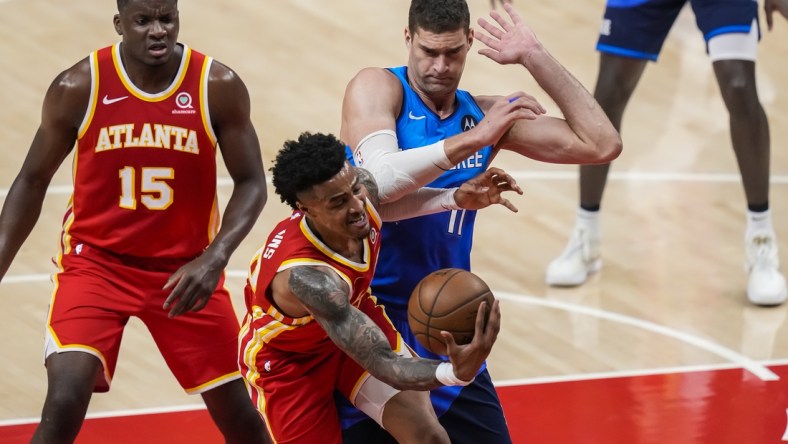 Jun 27, 2021; Atlanta, Georgia, USA; Atlanta Hawks forward John Collins (20) competes for rebound against Milwaukee Bucks center Brook Lopez (11) during the first quarter during game three of the Eastern Conference Finals for the 2021 NBA Playoffs at State Farm Arena. Mandatory Credit: Dale Zanine-USA TODAY Sports