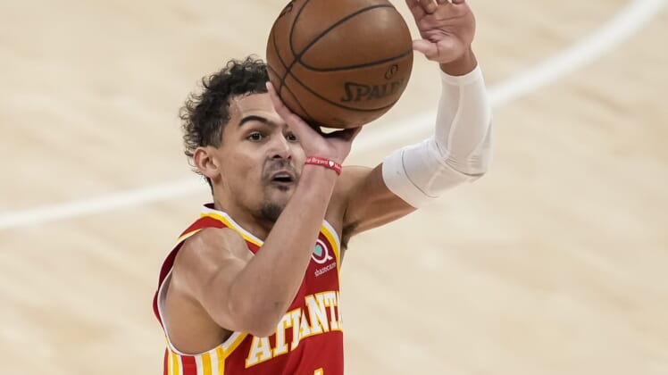 Jun 27, 2021; Atlanta, Georgia, USA; Atlanta Hawks guard Trae Young (11) shoots a three point shot against the Milwaukee Bucks during the first quarter during game three of the Eastern Conference Finals for the 2021 NBA Playoffs at State Farm Arena. Mandatory Credit: Dale Zanine-USA TODAY Sports