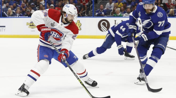 Jun 28, 2021; Tampa, Florida, USA; Montreal Canadiens left wing Phillip Danault (24) skates with the puck against Tampa Bay Lightning defenseman Victor Hedman (77) in the first period of game one of the 2021 Stanley Cup Final at Amalie Arena. Mandatory Credit: Kim Klement-USA TODAY Sports