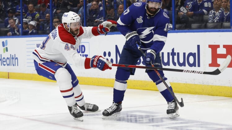 Jun 28, 2021; Tampa, Florida, USA; Tampa Bay Lightning left wing Alex Killorn (17) passes the puck away from Montreal Canadiens defenseman Joel Edmundson (44) in the second period of game one of the 2021 Stanley Cup Final at Amalie Arena. Mandatory Credit: Kim Klement-USA TODAY Sports