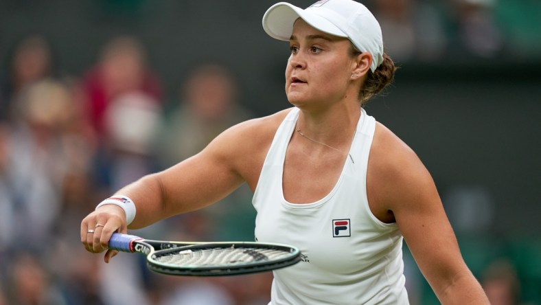 Jun 29, 2021; London, United Kingdom;  Ashleigh Barty (AUS) in action Carla Suarez Navarro (ESP) in first round ladies singles on centre court at All England Lawn Tennis and Croquet Club. Mandatory Credit: Peter Van den Berg-USA TODAY Sports