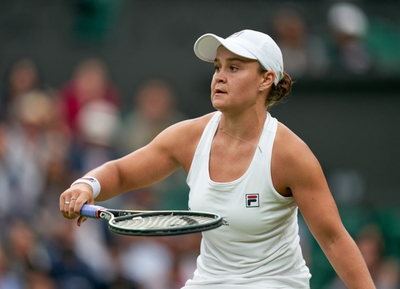 Jun 29, 2021; London, United Kingdom;  Ashleigh Barty (AUS) in action Carla Suarez Navarro (ESP) in first round ladies singles on centre court at All England Lawn Tennis and Croquet Club. Mandatory Credit: Peter Van den Berg-USA TODAY Sports