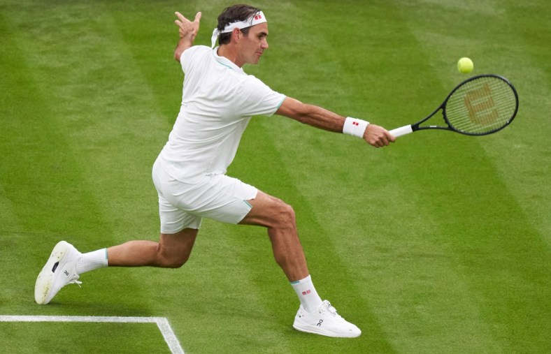 Jun 29, 2021; London, United Kingdom;  Roger Federer (SUI) in action Adrian Mannarino (FRA) in first round  singles on centre court at All England Lawn Tennis and Croquet Club. Mandatory Credit: Peter Van den Berg-USA TODAY Sports