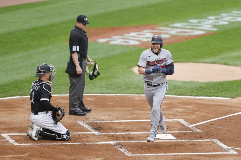 Jun 29, 2021; Chicago, Illinois, USA; Minnesota Twins third baseman Josh Donaldson (20) smiles as he crosses home plate after hitting a two run home run against the Chicago White Sox during the first inning at Guaranteed Rate Field. Mandatory Credit: Kamil Krzaczynski-USA TODAY Sports
