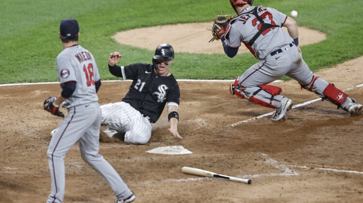 Jun 29, 2021; Chicago, Illinois, USA; Chicago White Sox catcher Zack Collins (21) scores a run as Minnesota Twins catcher Ryan Jeffers (27) waits for the ball during the fifth inning at Guaranteed Rate Field. Mandatory Credit: Kamil Krzaczynski-USA TODAY Sports