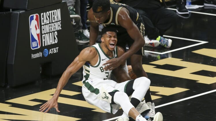 Jun 29, 2021; Atlanta, Georgia, USA; Milwaukee Bucks forward Giannis Antetokounmpo (34) and Atlanta Hawks center Clint Capela (15) fall to the floor as Antetokounmpo (34) is injured on the play in the third quarter during game four of the Eastern Conference Finals for the 2021 NBA Playoffs at State Farm Arena. Mandatory Credit: Brett Davis-USA TODAY Sports