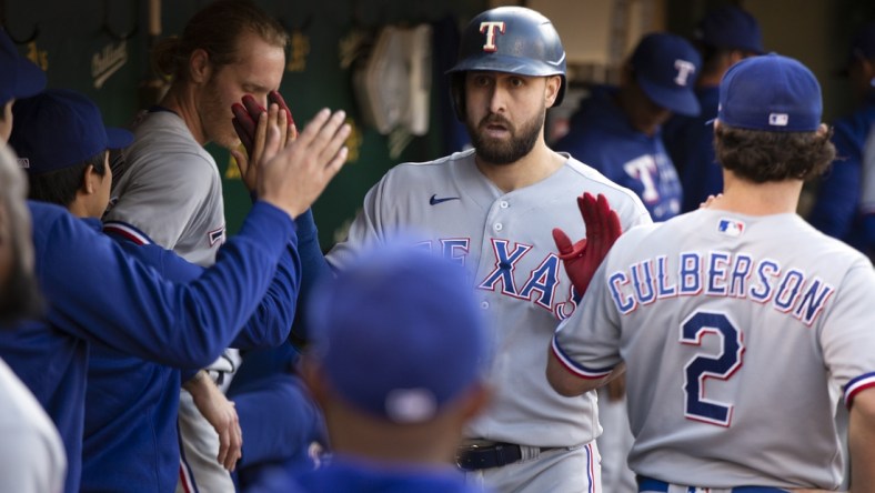 Jun 29, 2021; Oakland, California, USA; Texas Rangers right fielder Joey Gallo is greeted by his teammates after hitting a solo home run against the Oakland Athletics during the fourth inning at RingCentral Coliseum. Mandatory Credit: D. Ross Cameron-USA TODAY Sports