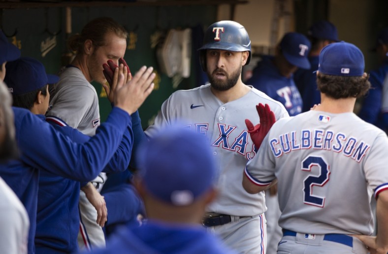 Jun 29, 2021; Oakland, California, USA; Texas Rangers right fielder Joey Gallo is greeted by his teammates after hitting a solo home run against the Oakland Athletics during the fourth inning at RingCentral Coliseum. Mandatory Credit: D. Ross Cameron-USA TODAY Sports