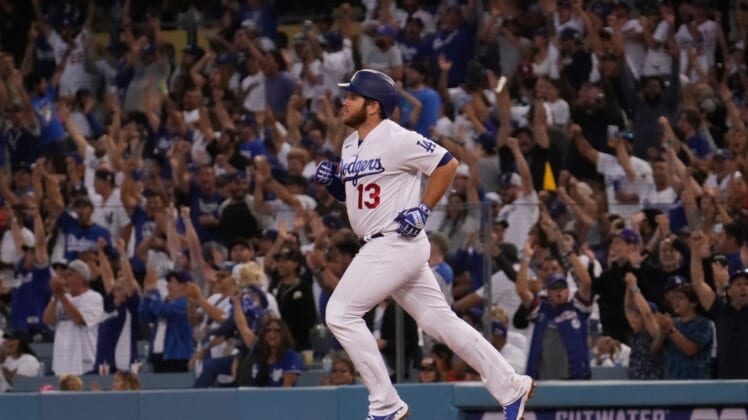Jun 29, 2021; Los Angeles, California, USA; Fans cheer as Los Angeles Dodgers first baseman Max Muncy (13) rounds the bases after hitting a home run in the fourth inning against the San Francisco Giants at Dodger Stadium. Mandatory Credit: Robert Hanashiro-USA TODAY Sports